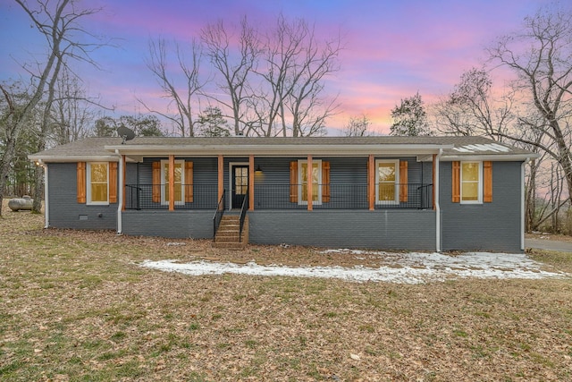 ranch-style house featuring a yard and a porch