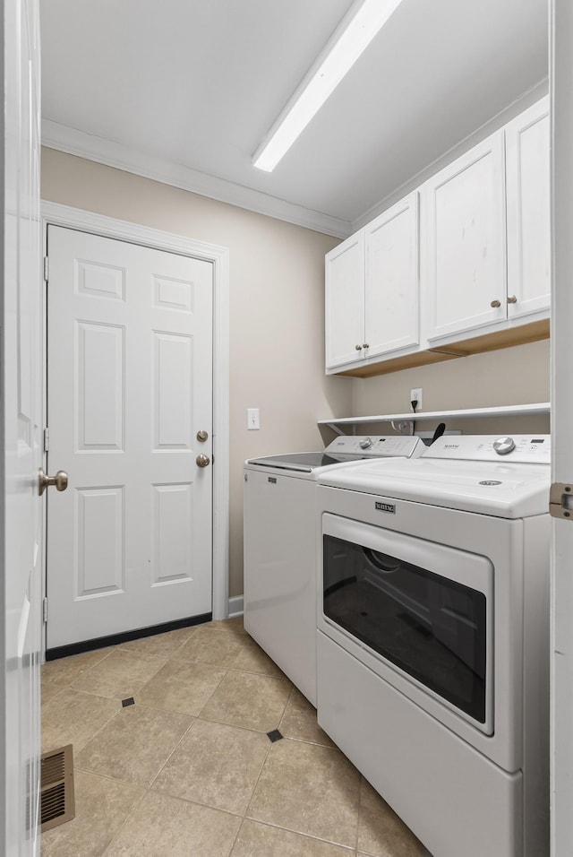 laundry area featuring independent washer and dryer, light tile patterned floors, cabinets, and crown molding