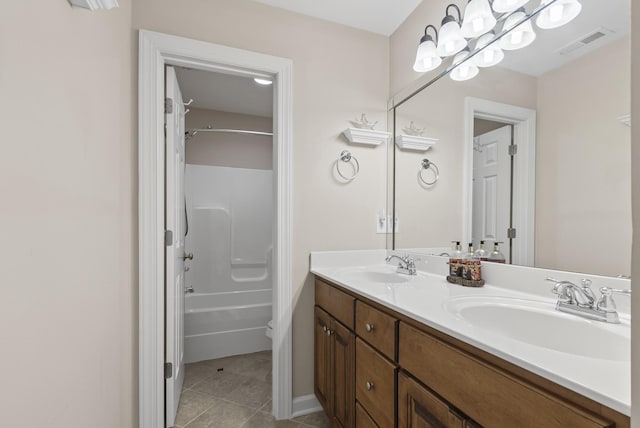 bathroom with shower / bathtub combination, tile patterned floors, and vanity