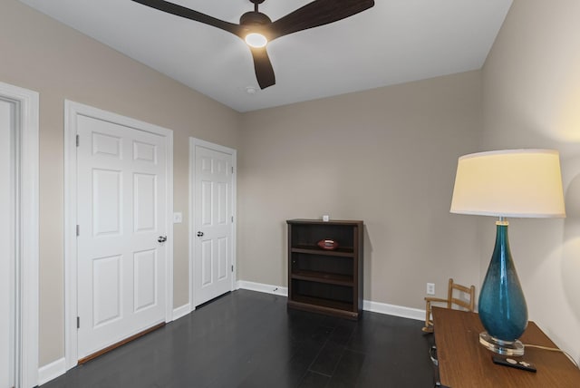 interior space featuring ceiling fan and dark wood-type flooring