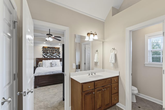 bathroom featuring vaulted ceiling, ceiling fan, toilet, vanity, and crown molding