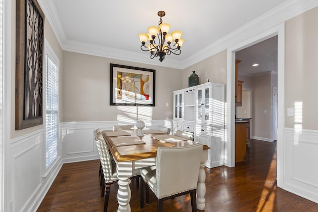 dining room with ornamental molding, a notable chandelier, and dark hardwood / wood-style floors