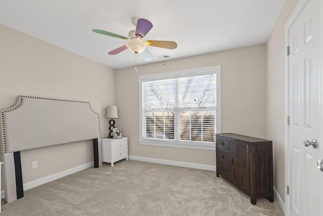 bedroom with ceiling fan and light carpet