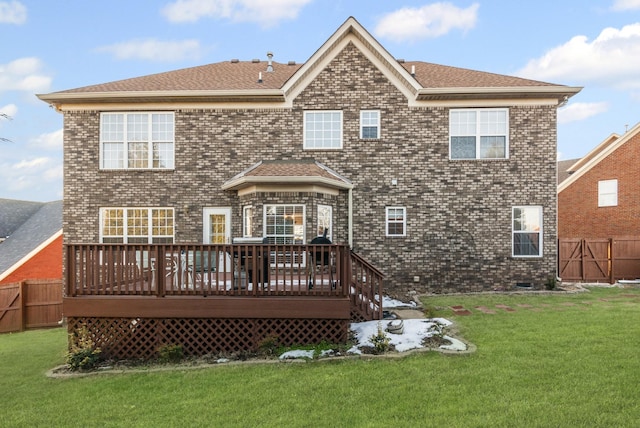 rear view of property featuring a lawn and a wooden deck