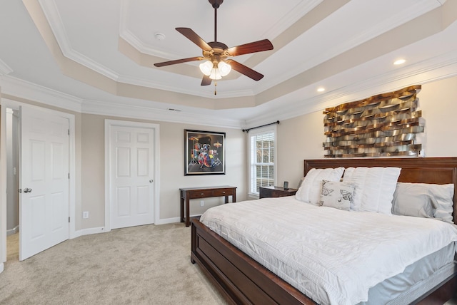 carpeted bedroom with ceiling fan, crown molding, and a raised ceiling