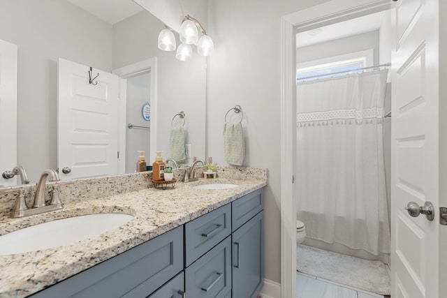 full bathroom featuring toilet, shower / tub combo with curtain, and vanity