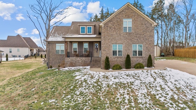 view of front of home featuring a yard and a porch