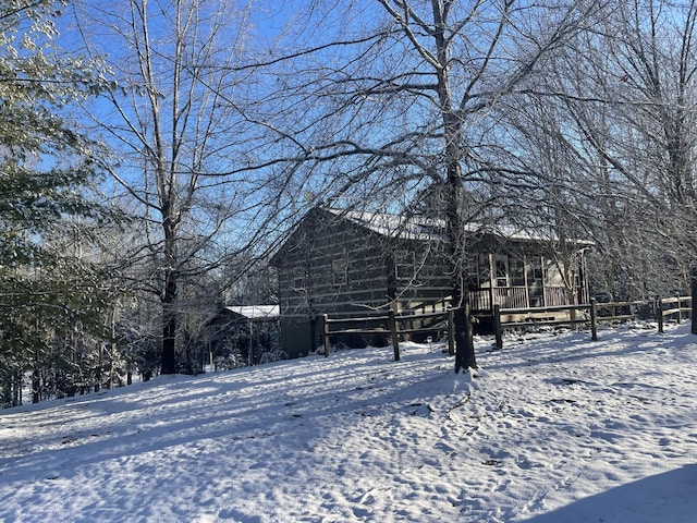 view of snowy exterior with a deck