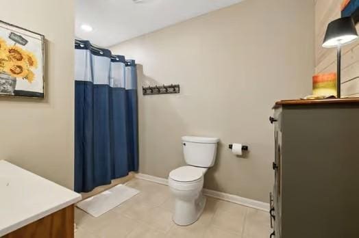 bathroom with curtained shower, toilet, vanity, and tile patterned flooring