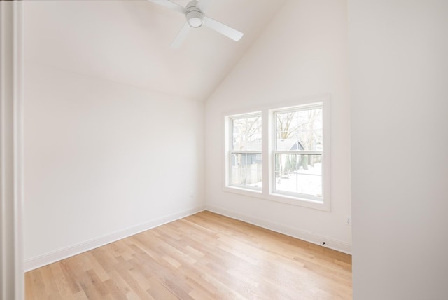 spare room with ceiling fan, vaulted ceiling, and light hardwood / wood-style flooring