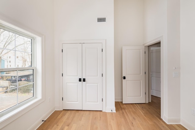 unfurnished bedroom featuring light wood-type flooring and a closet