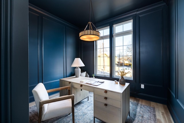 office featuring hardwood / wood-style floors and ornamental molding