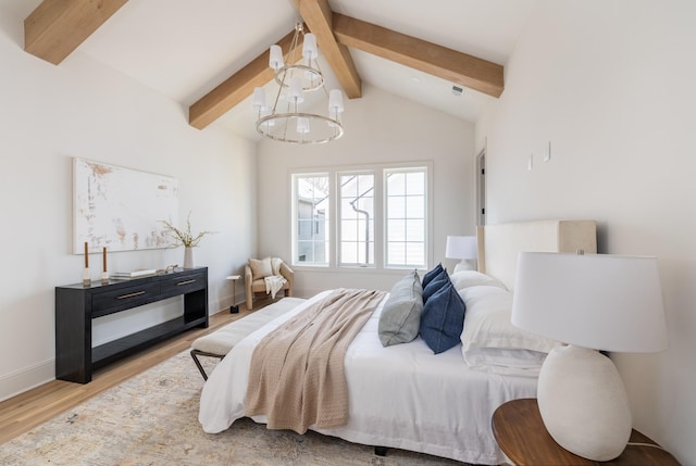 bedroom with a notable chandelier, light wood-type flooring, and vaulted ceiling with beams