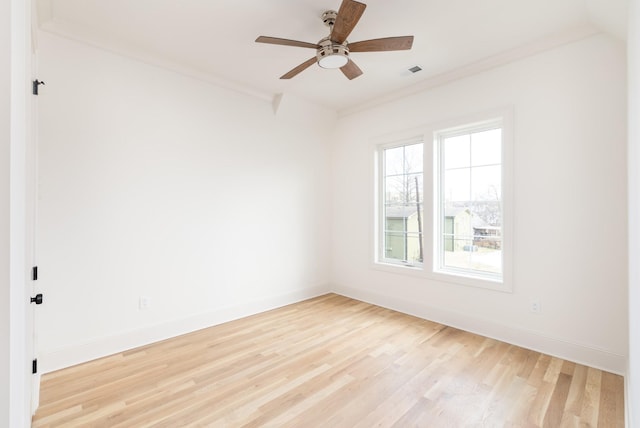 spare room with crown molding, ceiling fan, and light hardwood / wood-style flooring