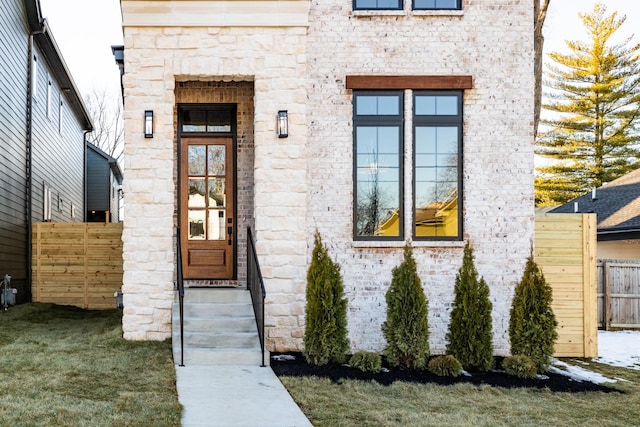 doorway to property featuring a lawn