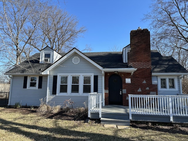 back of property with a yard and a wooden deck