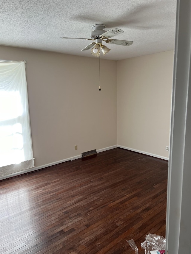 unfurnished room with dark hardwood / wood-style flooring, a textured ceiling, and ceiling fan