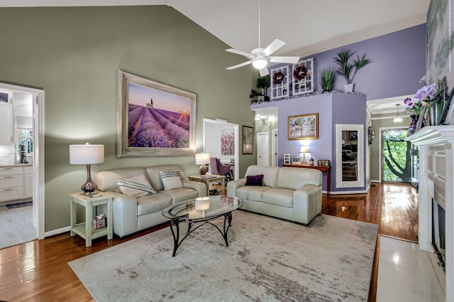 living room with high vaulted ceiling, a fireplace, ceiling fan, and hardwood / wood-style flooring