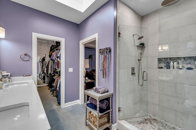 bathroom with a shower with door and vanity