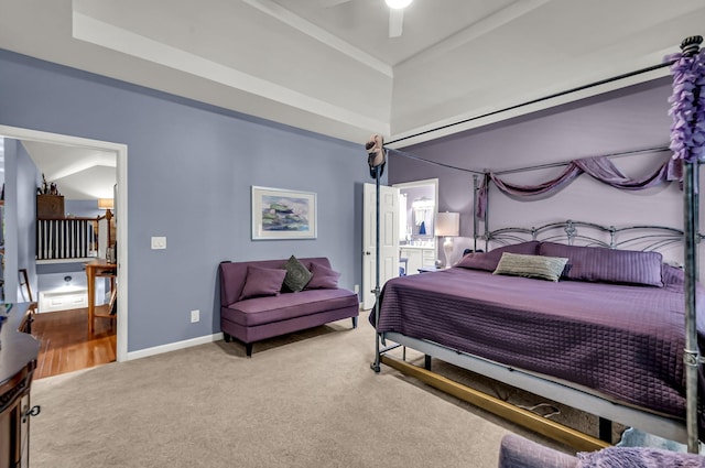 carpeted bedroom featuring vaulted ceiling, a raised ceiling, and ceiling fan