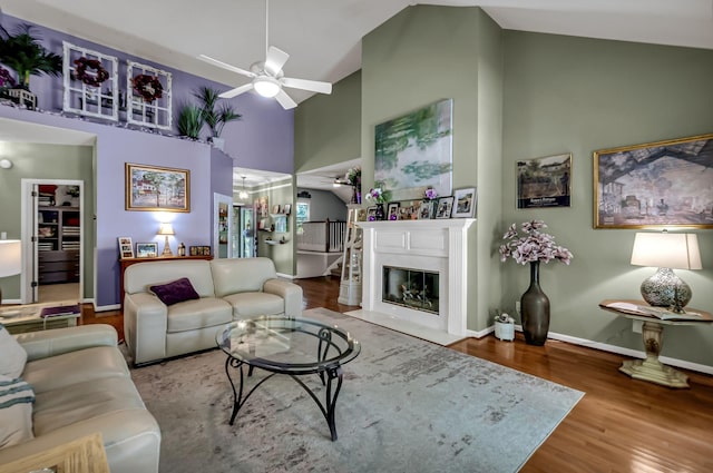 living room with wood-type flooring, high vaulted ceiling, and ceiling fan