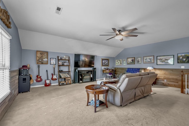 living room featuring lofted ceiling, a wealth of natural light, and light carpet