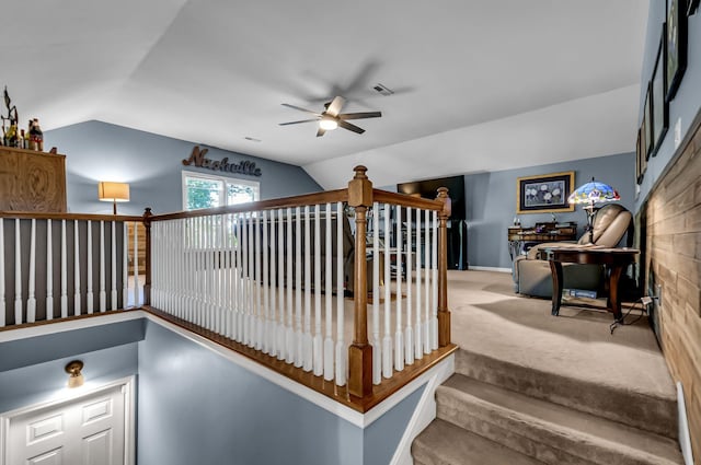 staircase with carpet, ceiling fan, and vaulted ceiling