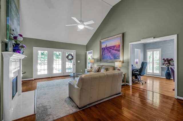 living room with high vaulted ceiling, ceiling fan, and hardwood / wood-style floors