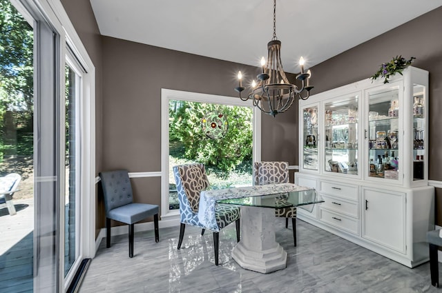 dining area featuring a healthy amount of sunlight and a notable chandelier