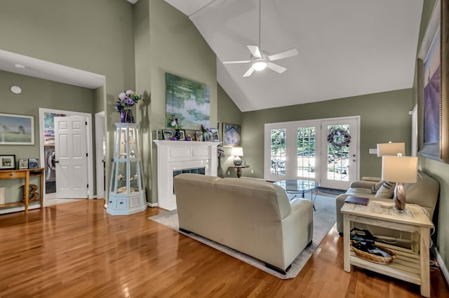 living room featuring ceiling fan, hardwood / wood-style floors, and high vaulted ceiling