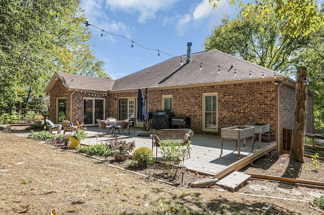 back of property featuring a wooden deck