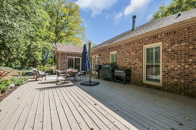 deck featuring an outdoor living space and area for grilling