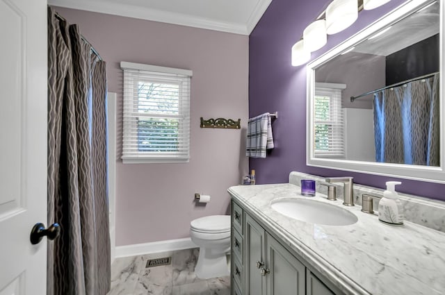 bathroom featuring toilet, vanity, ornamental molding, and a wealth of natural light