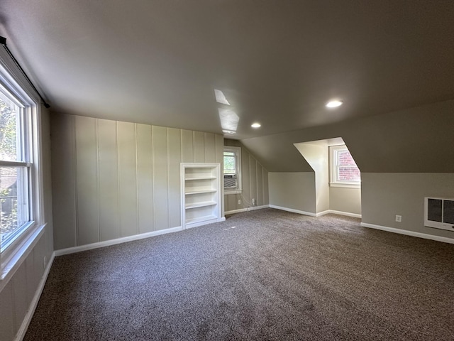 additional living space featuring lofted ceiling, cooling unit, carpet, and built in features