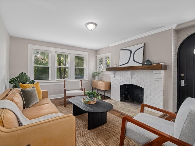 living room featuring a fireplace, ornamental molding, and hardwood / wood-style flooring