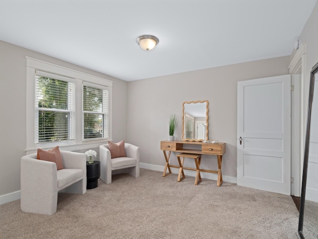 sitting room featuring light colored carpet