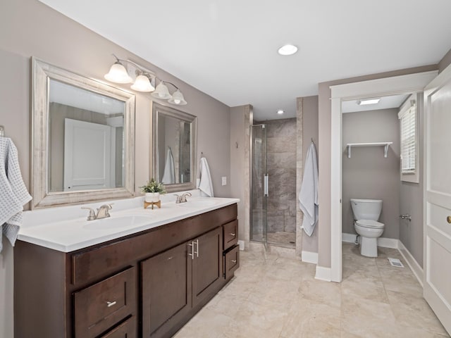 bathroom with toilet, a shower with shower door, and vanity