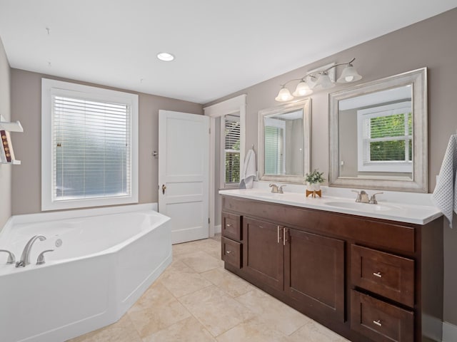 bathroom with a tub, tile patterned floors, and vanity