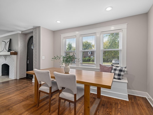 dining area featuring dark hardwood / wood-style flooring and a fireplace