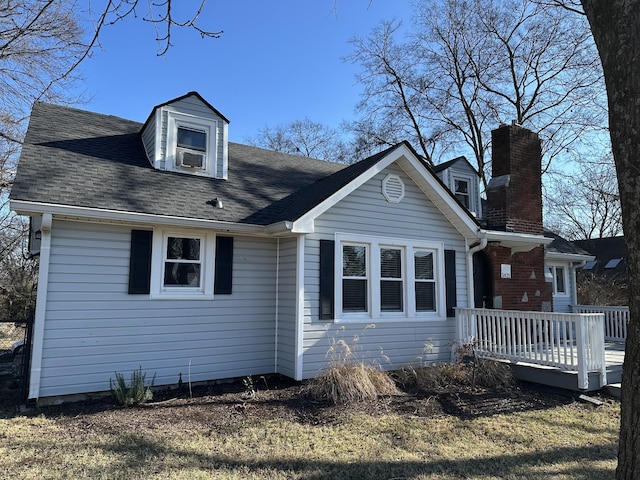 view of front of property with a deck and cooling unit