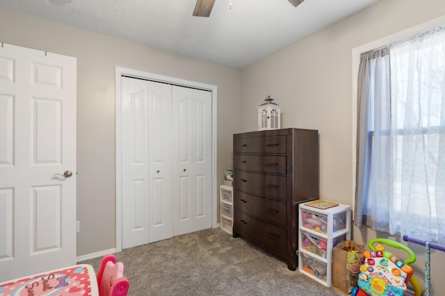 bedroom featuring ceiling fan, a closet, and light carpet