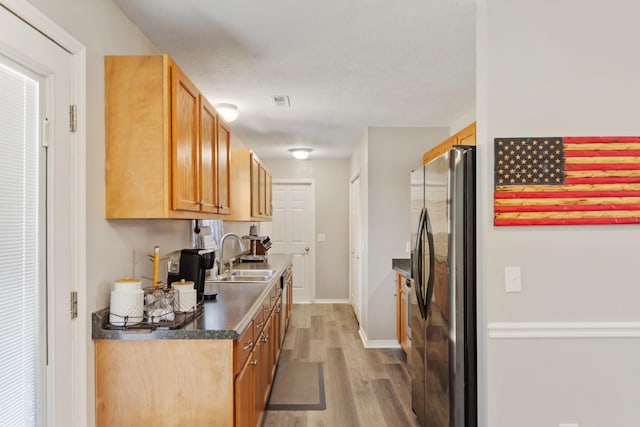 kitchen with sink, dark hardwood / wood-style flooring, and stainless steel fridge