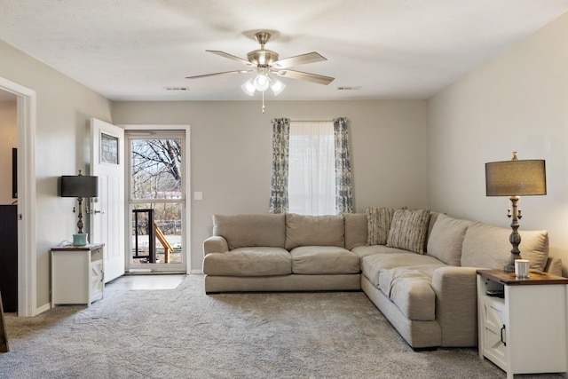 carpeted living room featuring ceiling fan