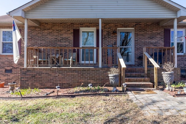 entrance to property featuring covered porch