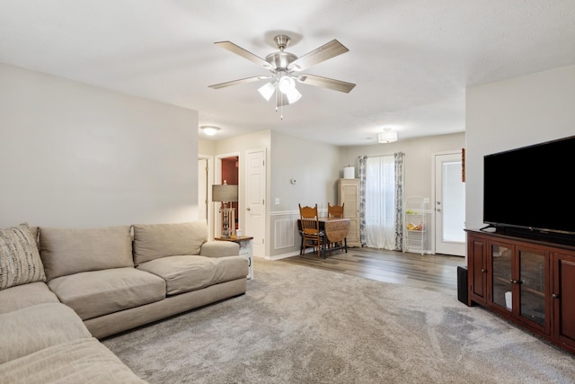 living room with ceiling fan and light hardwood / wood-style flooring