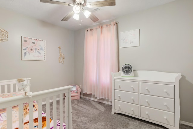 carpeted bedroom with a nursery area and ceiling fan