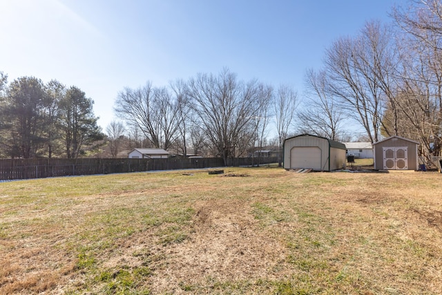 view of yard featuring a garage and a storage shed