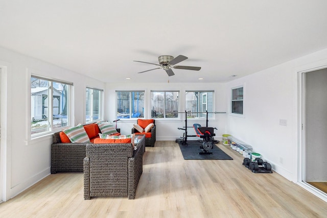 exercise area with ceiling fan, light hardwood / wood-style floors, and plenty of natural light