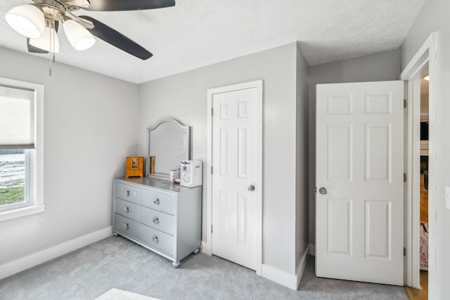 bedroom featuring ceiling fan and light colored carpet