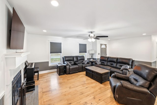 living room featuring light wood-type flooring and ceiling fan